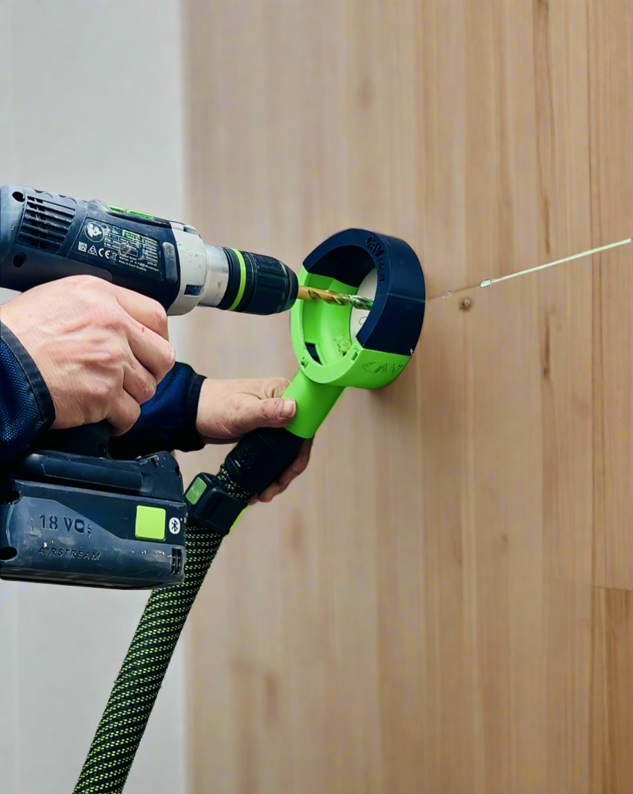 Free hand dust collector catching debris while drilling